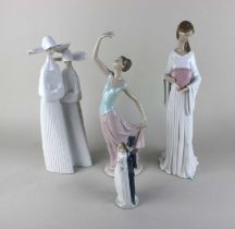 Two Lladro porcelain figures of two nuns 34cm high, and a woman holding a heart 37cm, together