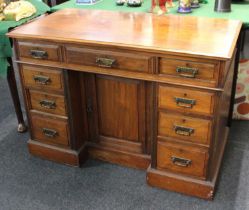 A 20th century mahogany kneehole desk with rectangular top above an arrangement of nine drawers with