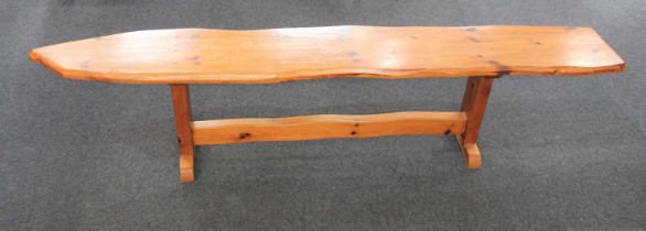 A rustic pine plank bench on trestle supports 179cm