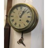 A brass cased ship's clock the 5 1/2 inch enamel dial with Roman and Arabic numerals, indistinctly