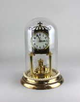 A German brass anniversary clock, 23cm high excluding base, under a glass dome (restored)