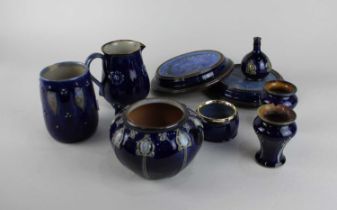 A collection of Royal Doulton blue glazed stoneware comprising sugar bowl, jug, vase, two