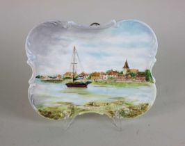 A handpainted porcelain plaque decorated with a view of Bosham Quay inscribed 'Bosham near