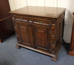 A 19th century Continental carved oak cabinet with dentil cornice, single panelled drawer and two
