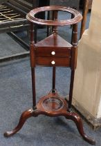 A George III mahogany wig / wash stand, the moulded circular dish top above two central drawers with