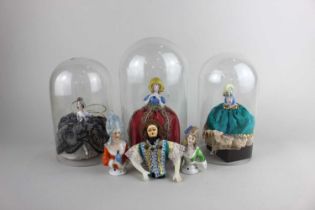 Three porcelain half dolls mounted on an upholstered fabric skirt base, two with separate attached