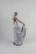 A Lladro porcelain figure of a dancer holding her skirts 31cm high