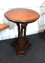 A 20th century mahogany occasional table with circular top, three carved swan head supports on