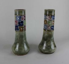 A pair of Royal Doulton glazed stoneware vases with a band of floral decoration, artist's initials