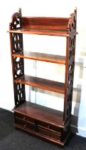 A Georgian style mahogany open bookcase with fretwork sides and four small drawers to base 51cm