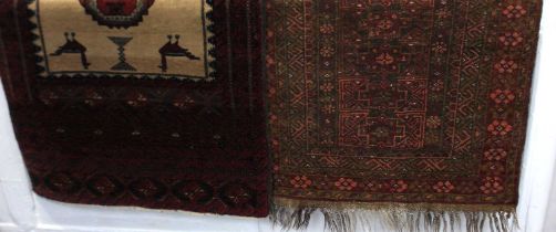 A Persian Balouch type rug with central geometric and bird motifs 139cm by 81cm, and a small