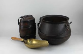 A metal cauldron cooking pot, an iron bound wooden flagon and a brass shovel with wooden handle (a/