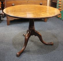 A George III oak circular tea table with folding top on tripod base, 80cm