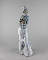 A Lladro porcelain figure of woman holding a Pekinese, 37cm high, boxed (a/f)