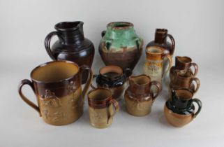 A collection of Royal Doulton glazed stoneware comprising of a large double handled cup, jug and