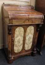 A Victorian walnut inlaid davenport, the piano lid enclosing a fitted interior with writing slide,