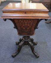 A Victorian rosewood sewing table the rectangular lifting top revealing a part fitted interior, on