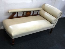 An Edwardian small cream leather chaise longue with galleried armrest, turned feet and castors,