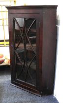 A 19th century oak corner cabinet with astragal glazed panel door enclosing three shelves 75cm, with