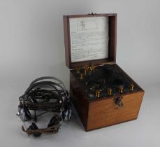 An early 20th century Radio Instruments Ltd. crystal radio box set with three sets of headphones,