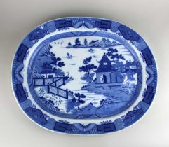 An oval blue and white willow pattern platter 47cm