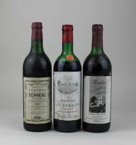 A bottle of Chateau Bonneau 1967 red wine a bottle of Chateau Le Barrail 1981 Medoc red wine and a