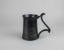 A studio pottery mug black pewter effect glaze with scroll handle, indistinct stamped mark to