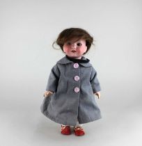 An Armand Marseille bisque head doll with sleeping brown eyes and open mouth revealing two teeth,