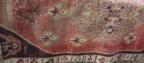 A Persian type rug, red ground, central floral medallion within multiguard borders 235cm by 143cm, a