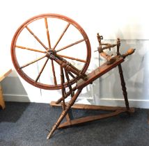 A wooden spinning wheel (af), 98cm