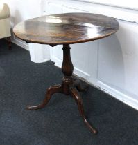 A George III oak circular tea table with fold over top, on baluster stem and tripod base, 74cm