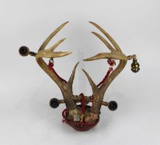 A set of antlers mounted for use as a wall light (a/f)
