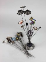 A collection of over thirty antique hat pins to include a pair of Charles Horner silver topped