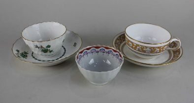 A Minton teacup and saucer with a grey yellow and gilt pattern, together with a tea cup and