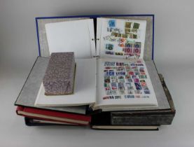 A collection of British and International stamps comprising six albums and some loose