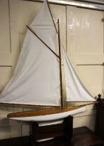 A wooden pond yacht with white sails on stand, height with stand 123cm