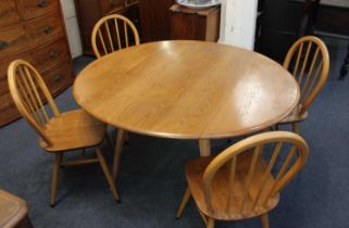 An Ercol blonde oval dropleaf dining table 121cm fully extended, together with four Ercol spindle