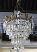 A brass mounted circular glass chandelier with four graduated tiers of glass spear drops, 29cm