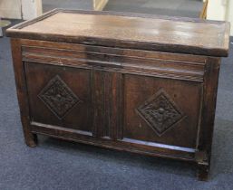 An 18th century small oak coffer with two carved panelled front on block feet, (a/f) 85cm