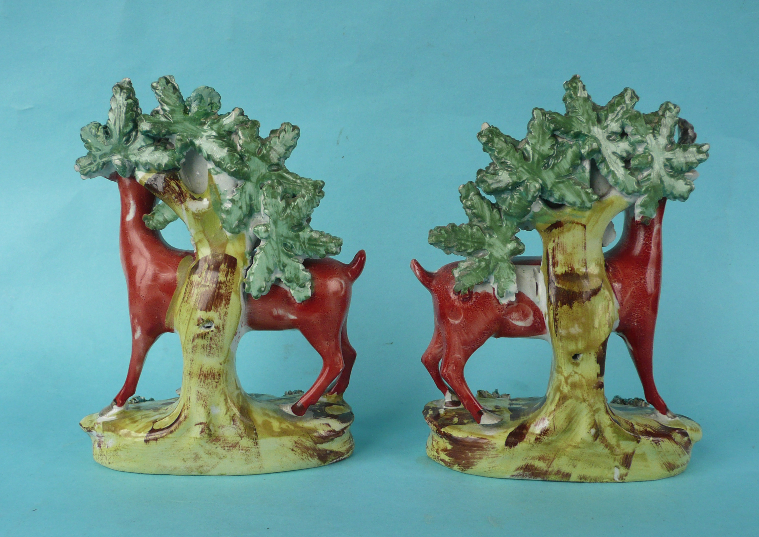 A pair of Staffordshire figures of deer depicted standing before a bocage on well painted bases - Image 2 of 3