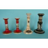 A pair of brick red ground candlesticks, another white, and an ‘Old Greek' pattern candlestick