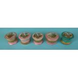 Three pink ground miniature trinket lids and bases, another lid and one other in green,