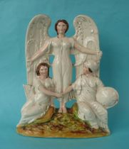 A Staffordshire pottery group depicting an angle standing between Britannia and Ireland