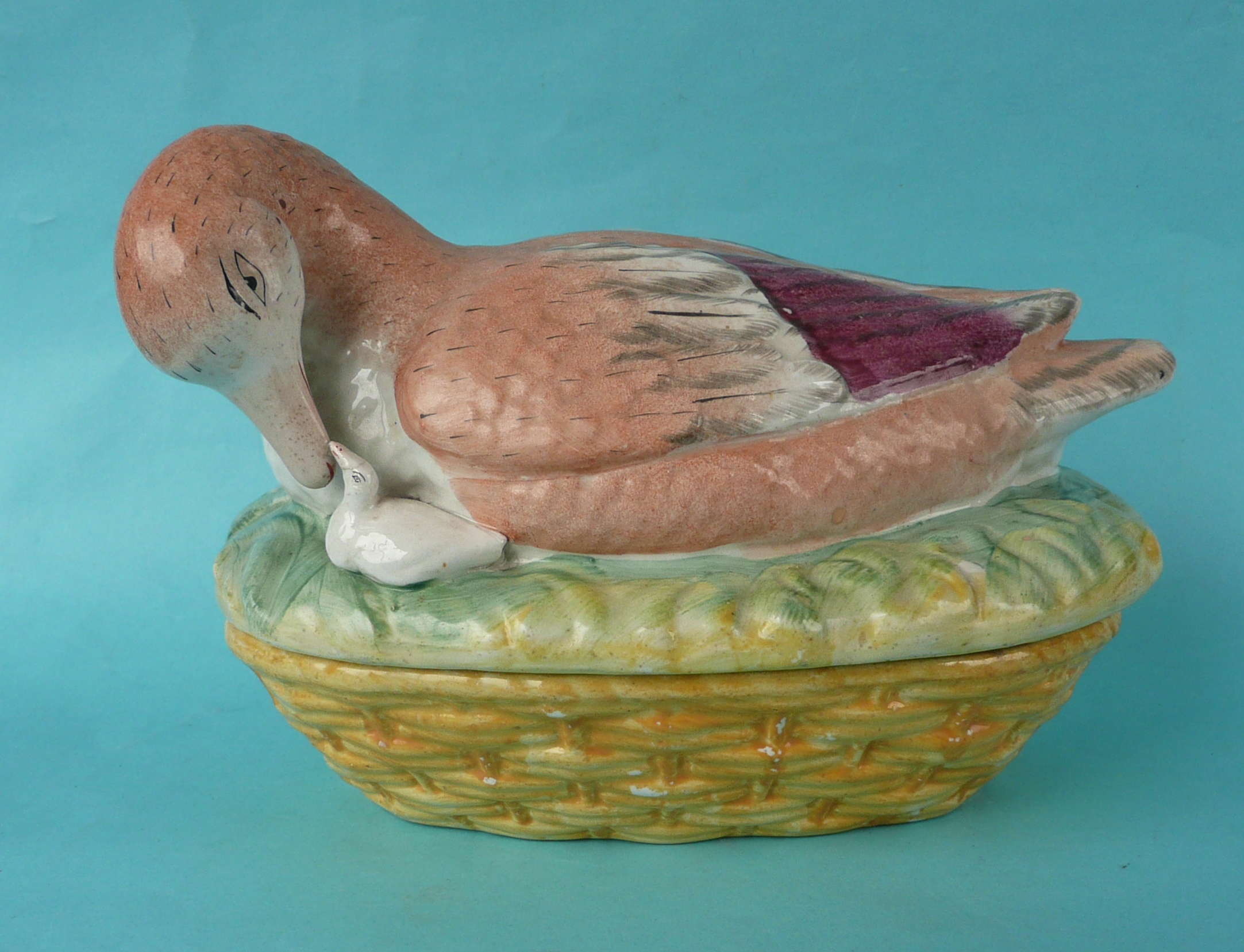 A good and colourful Staffordshire pottery tureen and cover modelled as a goose and gosling