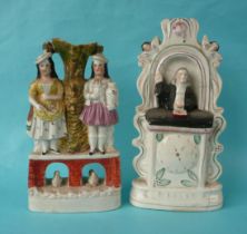 A colourful Staffordshire pottery group of two females standing upon a bridge with swans beneath