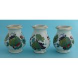 Three small baluster shaped jars with fruits and foliage