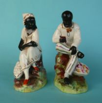 A pair of Staffordshire pottery figures by Thomas Parr depicting Uncle Tom and Aunt Chloe, circa
