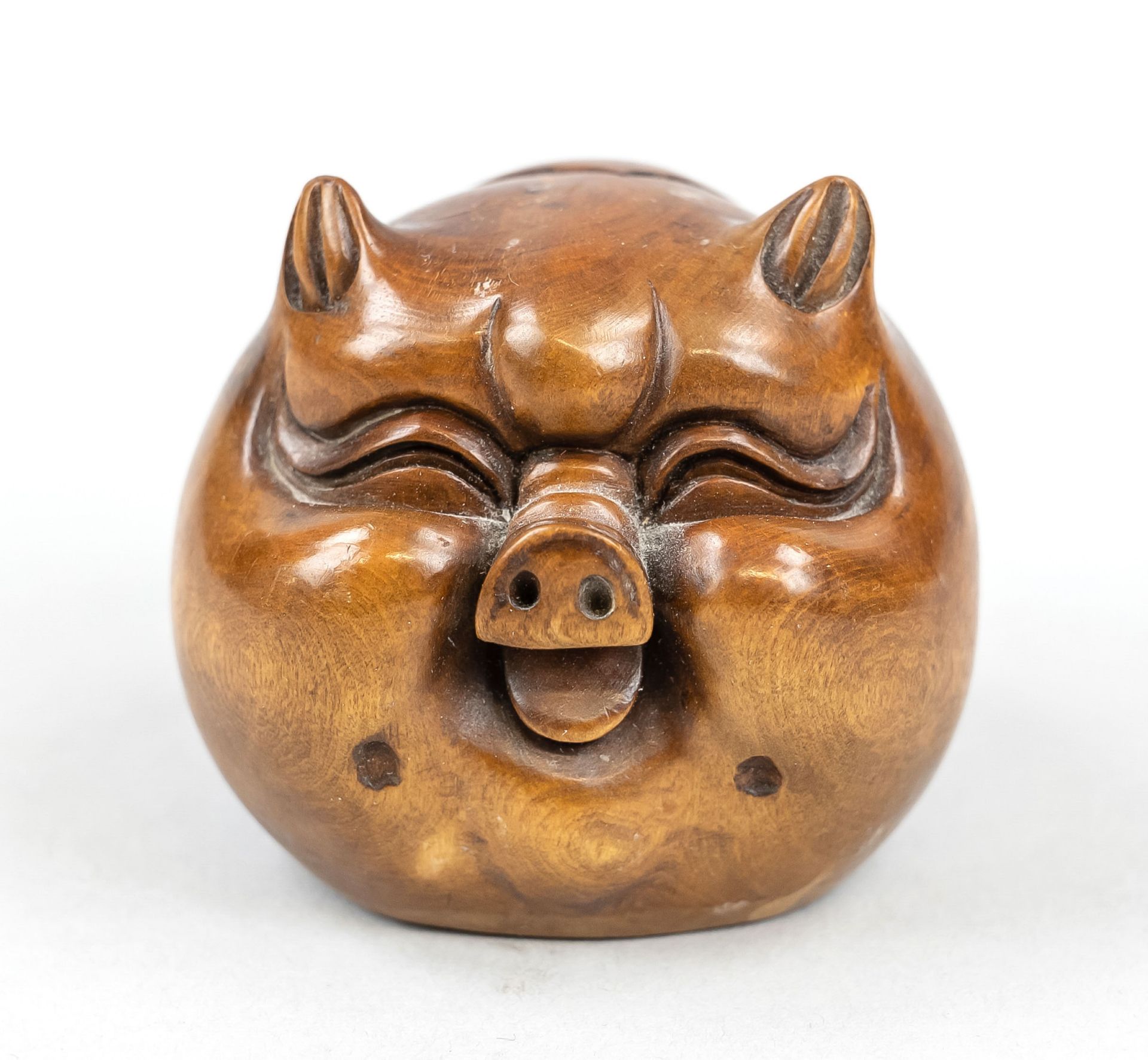 Hardwood netsuke ''ball pig'', China, 20th c., carved smiling ball of a pig's head with