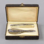 Brush and comb, German, 20th c., silver 800/000, with surrounding relief decoration band, comb