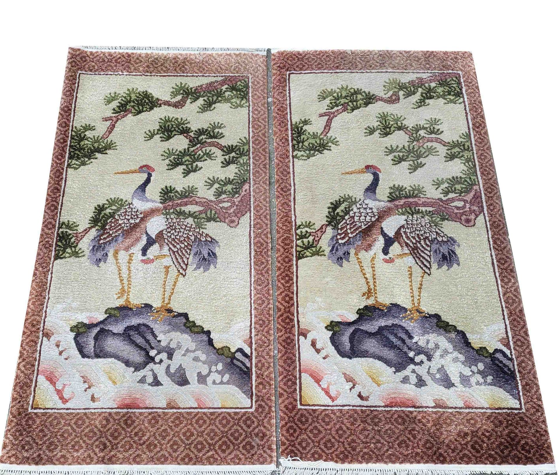 Pair of carpets, China, silk, slightly worn, fringes short on one side, each 124 x 62 cm